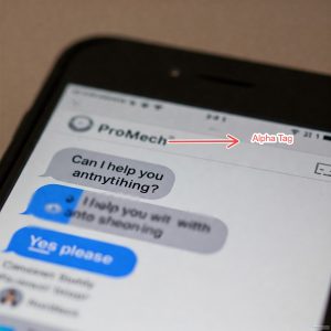 Close-up photo of a smartphone screen displaying a text message conversation. The sender's name is "ProMech" with an "Alpha Tag" indicator next to it. The conversation shows several messages